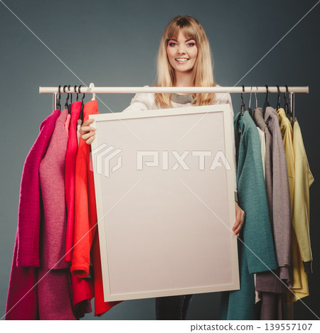 Woman in mall wardrobe with blank banner copyspace Woman in mall wardrobe with blank banner copyspace 139557107