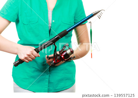Person holding fishing rod, spinning equipment. Person holding fishing rod, spinning equipment. 139557125