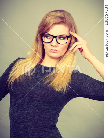 Closeup of woman thinking face expression Closeup of woman thinking face expression 139557134