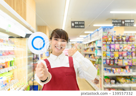Smiling store clerk giving a thumbs up Smiling store clerk giving a thumbs up 139557332