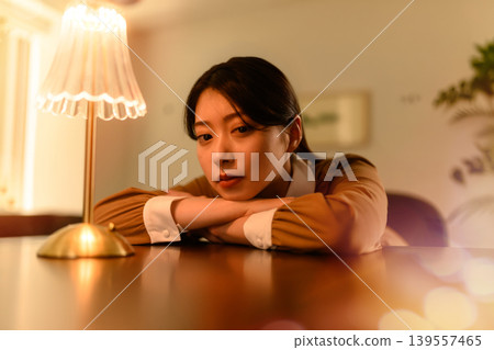 A woman troubled by the light of a lamp A woman troubled by the light of a lamp 139557465