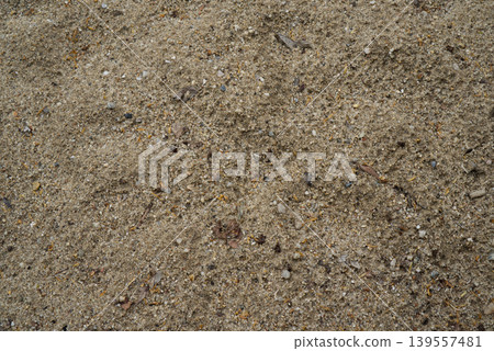 Texture of wet coarse-grained sand with small stones. 139557481