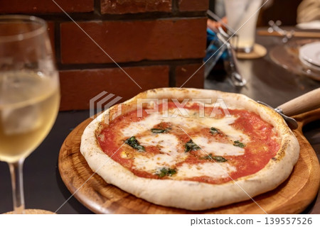 A Margherita pizza with melted cheese. 139557526