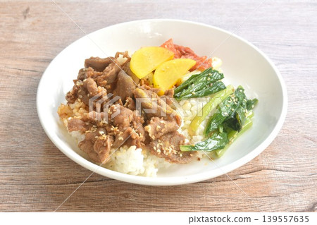 grilled pork with Bulgogi sauce Korean food with kimchi dressing slice yellow pickled radish topping rice on plate grilled pork with Bulgogi sauce Korean food with kimchi dressing slice yellow pickled radish topping rice on plate 139557635