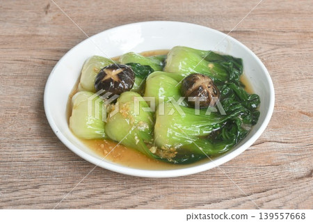 stir fried Chinese cabbage or Bok Choy topping black mushroom in gravy soy sauce on plate stir fried Chinese cabbage or Bok Choy topping black mushroom in gravy soy sauce on plate 139557668