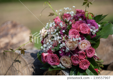 Close Up of Rose Wedding Bouquet on Wooden Logs Close Up of Rose Wedding Bouquet on Wooden Logs 139557907