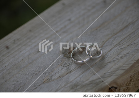 Two Wedding Rings on Wooden Surface Two Wedding Rings on Wooden Surface 139557967