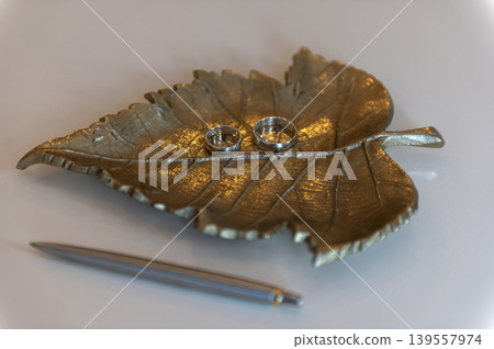 Wedding Rings on Decorative Metal Leaf Wedding Rings on Decorative Metal Leaf 139557974