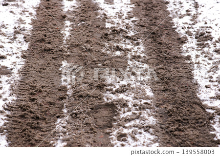 Repeating Vehicle Tracks In Melting Winter Surface Repeating Vehicle Tracks In Melting Winter Surface 139558003