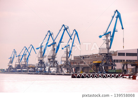 Frozen Industrial Harbor With Blue Cargo Cranes Frozen Industrial Harbor With Blue Cargo Cranes 139558008