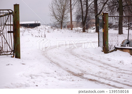 Industrial fence with small wooden structure in snow 139558016