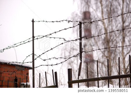Barbed Wire Fence With Industrial Ruins 139558051