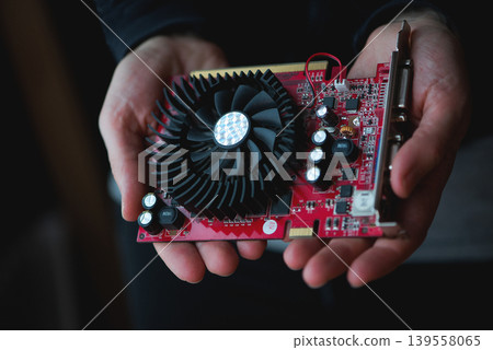 Graphics Card Held In Human Hands 139558065
