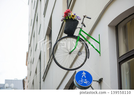 Creative Bicycle Wall Decoration With Flowers In Urban Street Scene 139558110