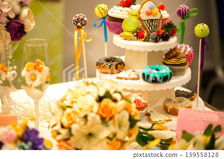 Decorative Sweet Table With Cakes Donuts And Colorful Desserts Decorative Sweet Table With Cakes Donuts And Colorful Desserts 139558128
