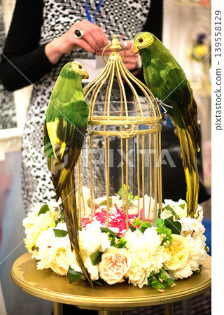 Two Green Parrots Sitting On Decorative Golden Cage Two Green Parrots Sitting On Decorative Golden Cage 139558129