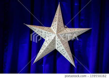 White Decorative Star Against Deep Blue Background White Decorative Star Against Deep Blue Background 139558162