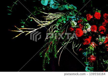 Dramatic Floral Arrangement With Red Roses And Dark Background Dramatic Floral Arrangement With Red Roses And Dark Background 139558164