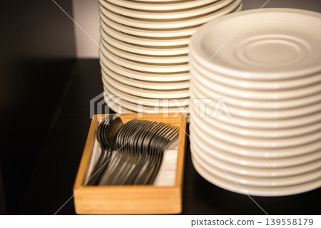 Stacked Plates And Cutlery Ready For Dining Stacked Plates And Cutlery Ready For Dining 139558179
