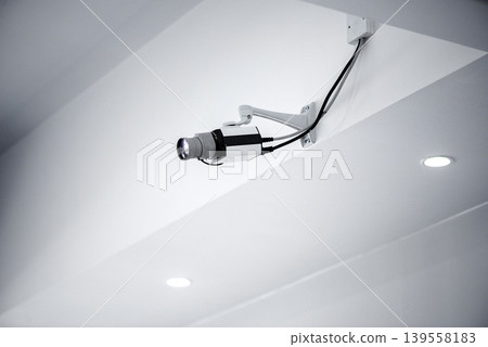Security camera mounted on ceiling in modern interior Security camera mounted on ceiling in modern interior 139558183