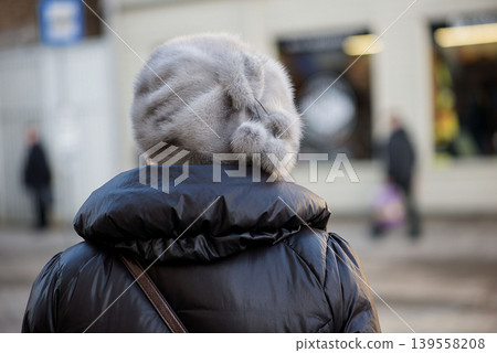 Senior woman wearing fur hat seen from behind Senior woman wearing fur hat seen from behind 139558208