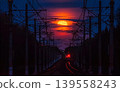 Red full moon rising over railroad tracks at twilight 139558243