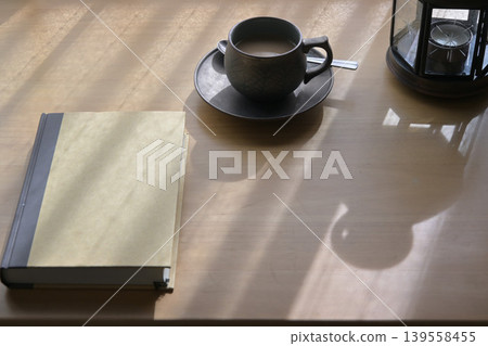 Coffee and a book on the table 139558455