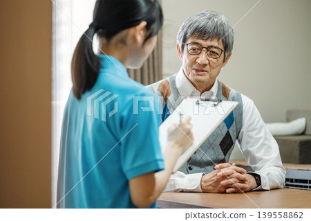 Senior man consults caregiver about his problems Senior man consults caregiver about his problems 139558862