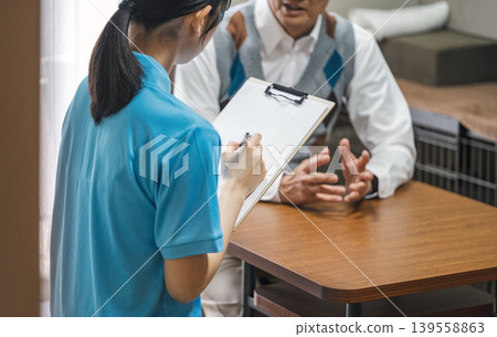 Image of a care worker listening to the concerns of clients. Image of a care worker listening to the concerns of clients. 139558863