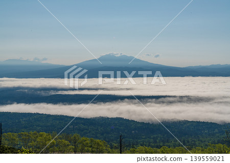 A dramatic morning scene of summer mountains and a sea of clouds in Hokkaido (early summer, June). A dramatic morning scene of summer mountains and a sea of clouds in Hokkaido (early summer, June). 139559021