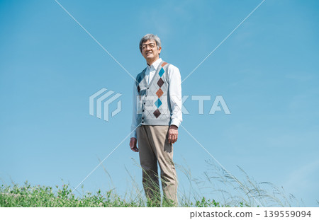 Portrait of a senior man strolling in a park Portrait of a senior man strolling in a park 139559094