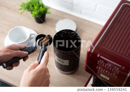 Preparing ground coffee for espresso machine at home Preparing ground coffee for espresso machine at home 139559241