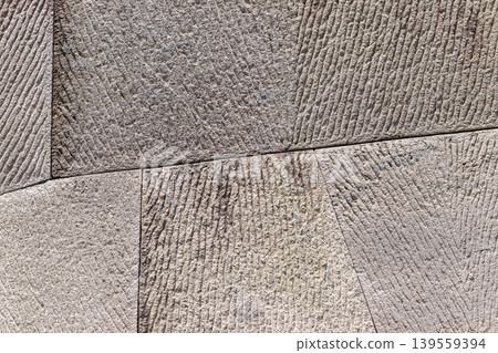 A background image of a flat, two-dimensional cutout of a model of a stone wall constructed using the traditional Japanese sanuki-zumi method (Kagoshima City). A background image of a flat, two-dimensional cutout of a model of a stone wall constructed using the traditional Japanese sanuki-zumi method (Kagoshima City). 139559394