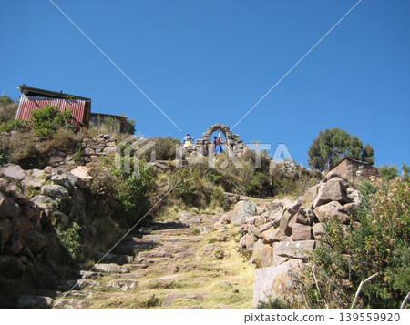 The walking trails on Taquile Island are made of stone and feature steep inclines. The walking trails on Taquile Island are made of stone and feature steep inclines. 139559920