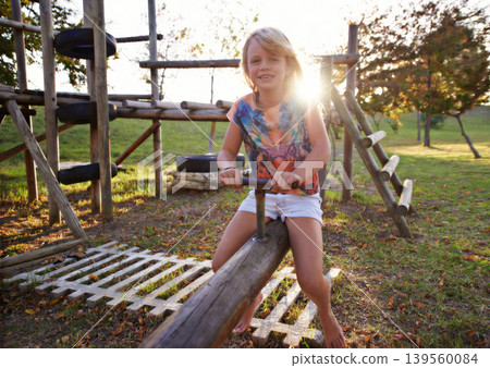 Happy girl, portrait and riding seesaw in park sunset for fun holiday, weekend or outdoor break in nature. Face of female person, kid or child smile on playground for childhood activity outside Happy girl, portrait and riding seesaw in park sunset for fun holiday, weekend or outdoor break in nature. Face of female person, kid or child smile on playground for childhood activity outside 139560084