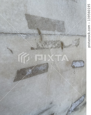 Close Up Of Adhesive Tape Residue And Marks On Concrete Wall 139560195