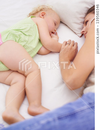 Love, sleeping and mom with toddler on bed for bonding, relax and sweet cute family time. Happy, smile and young mother watching girl child, kid or baby taking a nap in bedroom or nursery at home. Love, sleeping and mom with toddler on bed for bonding, relax and sweet cute family time. Happy, smile and young mother watching girl child, kid or baby taking a nap in bedroom or nursery at home. 139560346