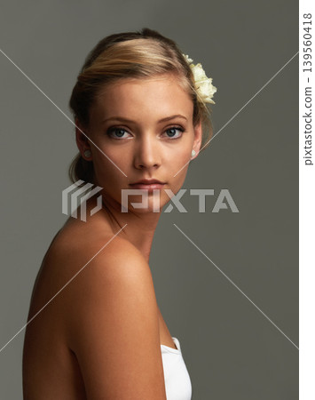 Portrait, cosmetics and woman with natural beauty, flowers and shine isolated on grey studio background. Face, person and model with texture, skincare and grooming with aesthetic and healthy skin Portrait, cosmetics and woman with natural beauty, flowers and shine isolated on grey studio background. Face, person and model with texture, skincare and grooming with aesthetic and healthy skin 139560418