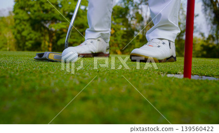 Golfers are putting golf in the evening golf course golf backglound. Golfers are putting golf in the evening golf course golf backglound. 139560422