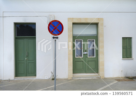the no-stopping sign between two doors in a street in Larnaka, Cyprus the no-stopping sign between two doors in a street in Larnaka, Cyprus 139560571