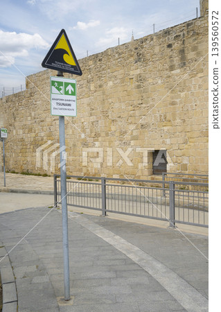 the sign indicating the escape route from a possible tsunami in a street in Larnaka, Cyprus the sign indicating the escape route from a possible tsunami in a street in Larnaka, Cyprus 139560572