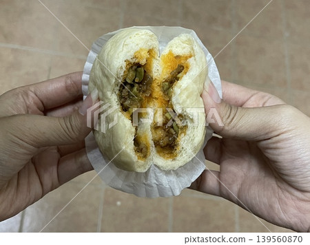 Hands Pulling Apart Steamed Bun With Spicy Petai Bean Filling Hands Pulling Apart Steamed Bun With Spicy Petai Bean Filling 139560870