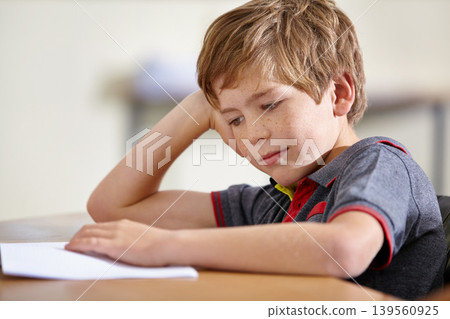 Class, notebook and bored child at desk, learning and education with school exam. Reading book, studying for test and boy student in classroom with knowledge and thinking with depression on project. Class, notebook and bored child at desk, learning and education with school exam. Reading book, studying for test and boy student in classroom with knowledge and thinking with depression on project. 139560925