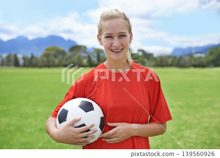 Woman, field and portrait with soccer ball, happy and football pitch for match, competition or game. Fitness, practice and ready for training, outdoor and exercise for athlete, strong and sport 139560926