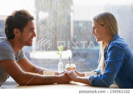 Holding hands, cafe or happy couple on date talking or speaking of anniversary or holiday vacation. Tea drink, woman or romantic man in conversation for care, love or support to relax in coffee shop Holding hands, cafe or happy couple on date talking or speaking of anniversary or holiday vacation. Tea drink, woman or romantic man in conversation for care, love or support to relax in coffee shop 139561182