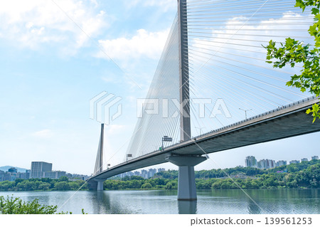 Seoul, South Korea - May. 10, 2026 : Guri-Topyeong Bridge and a peaceful riverside walking path along the Han River in Guri, South Korea 139561253