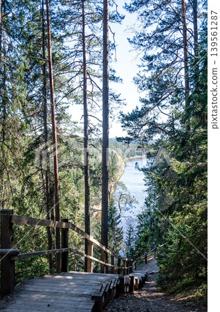 View of river trail in Gauja National Park with forest and stone formations View of river trail in Gauja National Park with forest and stone formations 139561287