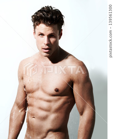 Shower, body and portrait of man with water for washing, cleaning and skincare wellness. Shirtless and muscular male model person with grooming and hygiene for healthy skin by white studio background Shower, body and portrait of man with water for washing, cleaning and skincare wellness. Shirtless and muscular male model person with grooming and hygiene for healthy skin by white studio background 139561300
