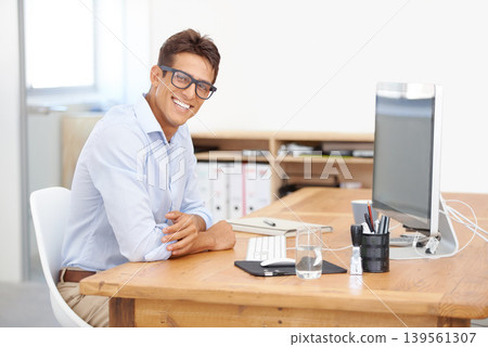 IT support, portrait or happy man with computer at desk with information for web design or solution. Smile, business or employee programming with glasses or research online on screen on pc in office 139561307
