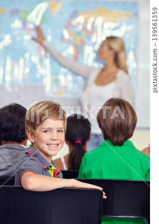 Kid, portrait and classroom with teacher for education, teaching and geography lesson or support in primary school. Face of a boy, child or students for learning, map information and world knowledge Kid, portrait and classroom with teacher for education, teaching and geography lesson or support in primary school. Face of a boy, child or students for learning, map information and world knowledge 139561359